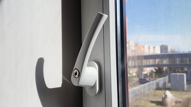 Plastic window handle. Open plastic window, airing the room.