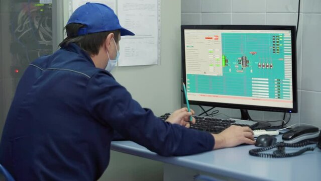 Male Factory Specialist Is Making Settings For Production Equipment In The Computer Program. Working Process. Manufacturing Of Dairy Products. Inside A Modern Plant. Food Industry.