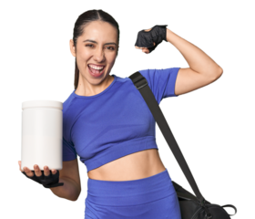 Fitness young Caucasian woman with protein and bag on studio background raising fist after a victory, winner concept.