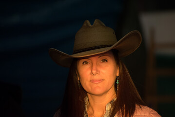 Wonderful woman with cowboy hat at sunset