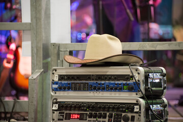
Cowboy hat resting on top of a mixer at a country festival