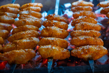 Turkish mixed grill meat, chicken wings, lamb, beef shashlik, kebab cooking on charcoal grill in restaurant