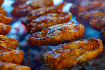 Turkish mixed grill meat, chicken wings, lamb, beef shashlik, kebab cooking on charcoal grill in restaurant
