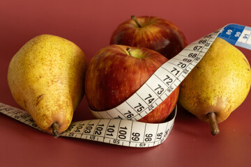 Tape measure and apple symbolizing diet and obesity