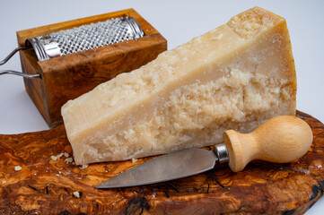 Traditional italian food - 22 months aged in caves Italian parmesan hard cheese from Parmigiano-Reggiano, Italy