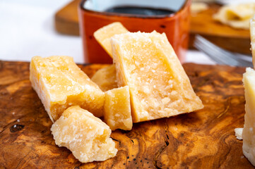 Tasting of 24 and 48 months aged Italian parmesan hard cheese from Parmigiano-Reggiano, Italy and balsamico vinegar from Modena