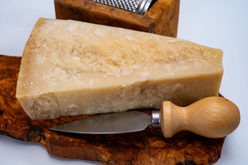 Traditional italian food - 22 months aged in caves Italian parmesan hard cheese from Parmigiano-Reggiano, Italy