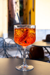 Aperol Spritz orange bitter long drink cocktail made with liqueur, prosecco sparkling wine, ice cubes and piece of orange, Milan, Italy