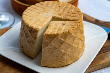 Cheese collection, piece of fresh smoked Spanish goat cheese close up