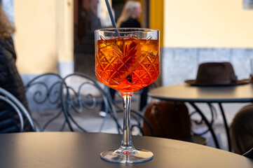 Aperol Spritz orange bitter long drink cocktail made with liqueur, prosecco sparkling wine, ice cubes and piece of orange, Milan, Italy