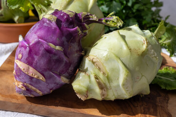 Heads of fresh ripe bio white and purple cabbage kohlrabi from organic farm, close up