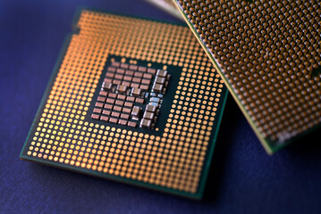 A computer processor on a blue background. Contacts on the processor case.