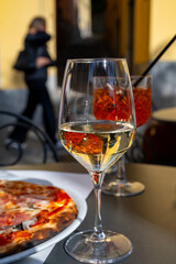 Glass of cold dry white wine served outdoor in cafe in Bellagio, Como lake, Italy