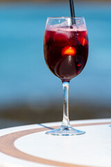 Glass of cold sangria wine served with orange in beach cafe, Corralejo, Fuerteventura, Spain