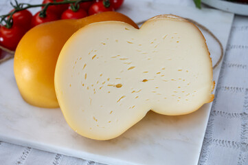 Cheese collection, Italian cheese scamorza, caciocavallo, provolone made from cow milk in South Italy yellow smoked cheese