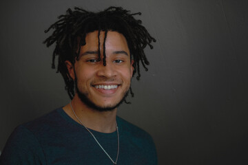 Indoor portrait of young handsome African-American man smiling