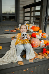 little girl with pumpkin on Halloween 
