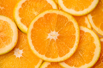 Closeup of sliced juicy oranges textured background