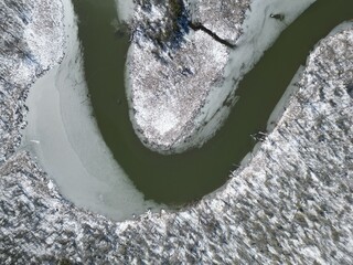 curved river arm seen from above in a snow-covered landscape