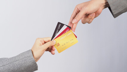 Hands are sent and receive credit cards on white background.
