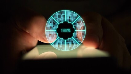 Cg digital pie chart of turquoise color showing one hundred percent load by sector is divided into squares creating a flickering effect against the background of hands using a smartphone in the dark - Powered by Adobe