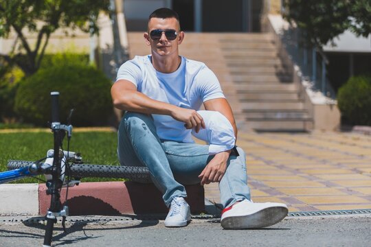 Man with a bicycle on outdoor background