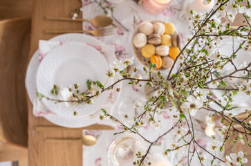 Spring Easter decor. Easter table setting. Flowers and dishes and candles for a festive dinner. High quality 
