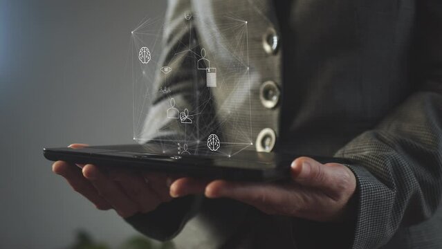 Cg symbols of the development and digitalization of human society on a polygonal network moving over a tablet in the hands of a woman