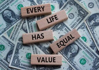 Equality symbol. Wooden blocks with words Every Life has Equal Value. Beautiful dollar background....