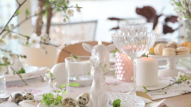 Spring Easter decor. Easter table setting. Flowers and dishes and candles for a festive dinner. High quality footage