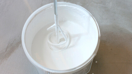 White paint for walls. The mixer mixes the paint.