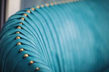 Luxury of blue fabric. beautiful blue velour frabic sofa decorate with golden buttons. Blue teal...