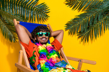 Photo of handsome man wear print hawaii shirt in sunglass enjoy lay at resort hold palms behind...