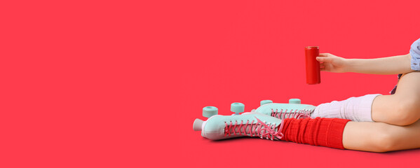 Woman in roller skates with soda on red background