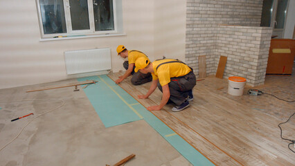 Laying parquet board in the apartment. Repair in the house.