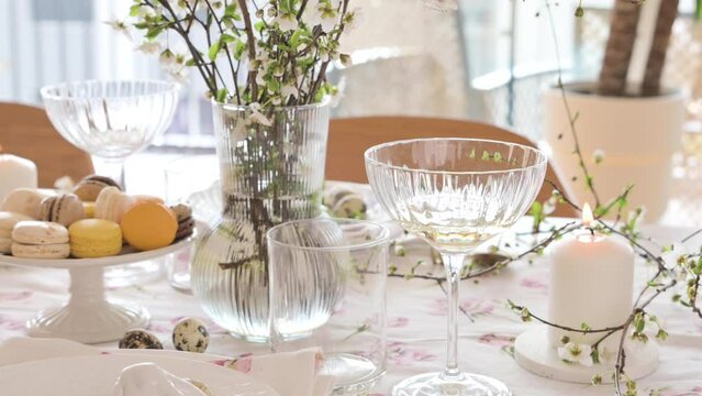 Spring Easter decor. Easter table setting. Flowers and dishes and candles for a festive dinner. High quality footage