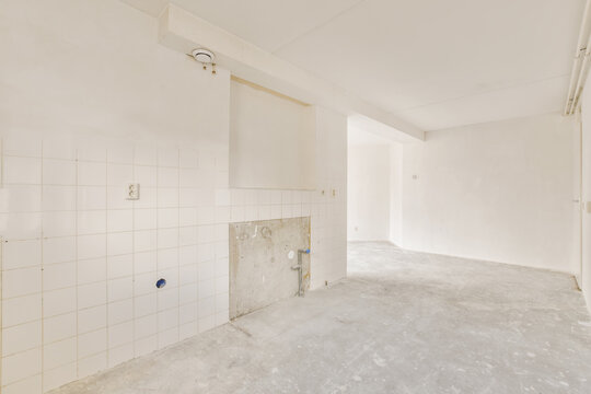 Empty room ready for renovation with tiled walls