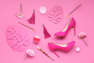 Composition with stylish female shoes, accessories, cosmetics and flowers on pink background - obrazy, fototapety, plakaty