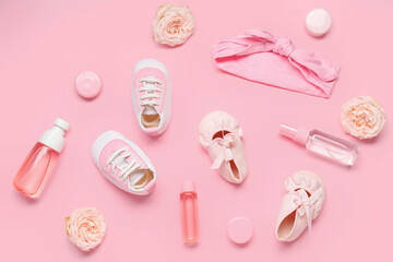 Composition with baby accessories, cosmetics and flowers on pink background