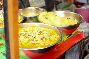selling thai Green curry with meatballs, eggplant , coconut shoots and bamboo shoots in the market