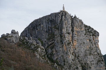 rocky cliff of Castellane, soutern France with the old stone church above