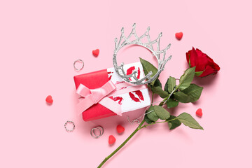 Composition with silver crown, gift box and rose flower on pink background