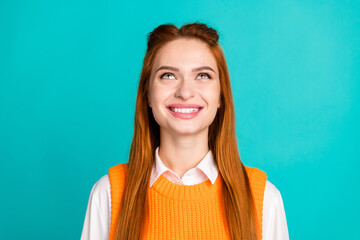 Photo portrait of pretty young girl look up empty space wear trendy orange knitwear outfit isolated on cyan color background