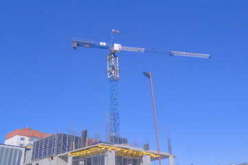Fototapeta na wymiar Construction tower crane on a construction site.