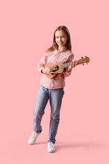 Teenage girl playing ukulele on pink background
