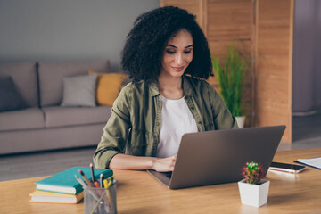 Photo of happy positive lady entrepreneur dressed shirt communicating modern device indoors...