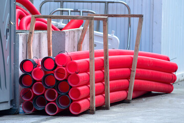 red corrugated pipes for  water or communications or sewer for install  in construction site on street city - 770022484
