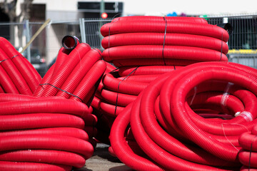 red corrugated pipes for  water or communications or sewer for install  in construction site on street city - 770022499
