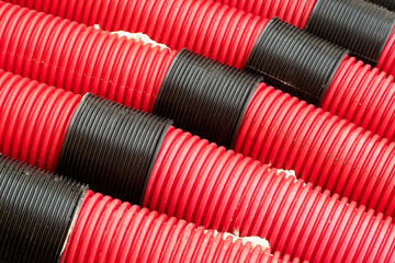red corrugated pipes for  water or communications or sewer for install  in construction site on street city - 770022601