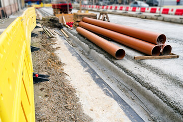 red corrugated pipes for  water or communications or sewer for install  in construction site on street city - 770022620